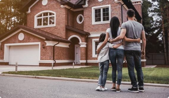 a group of people standing in front of a house