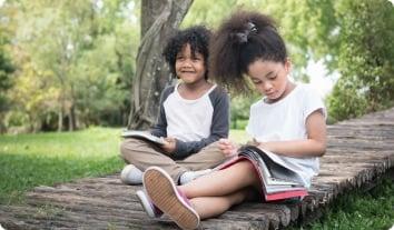 a couple of children sitting on a bench