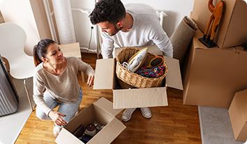 A man and a woman opening boxes