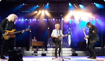 a group of people playing instruments on a stage