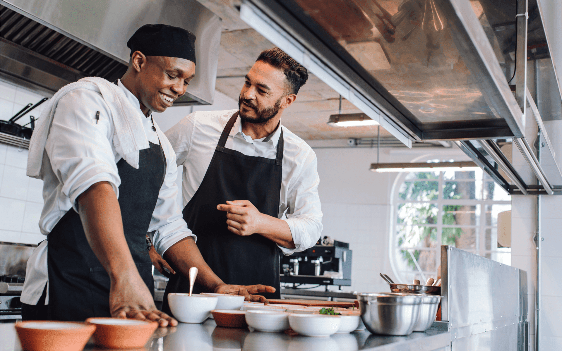 a couple of chefs in a kitchen