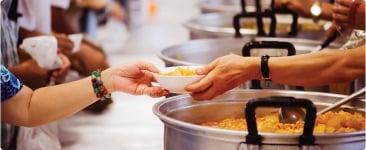 a group of people preparing food