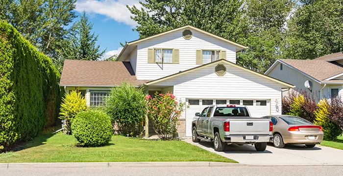 a couple of cars parked in front of a house