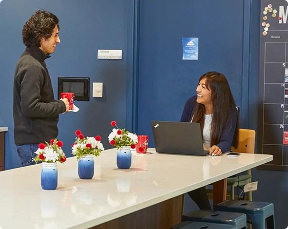 a man and a woman looking at a laptop