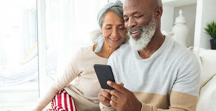 a man and woman looking at a phone