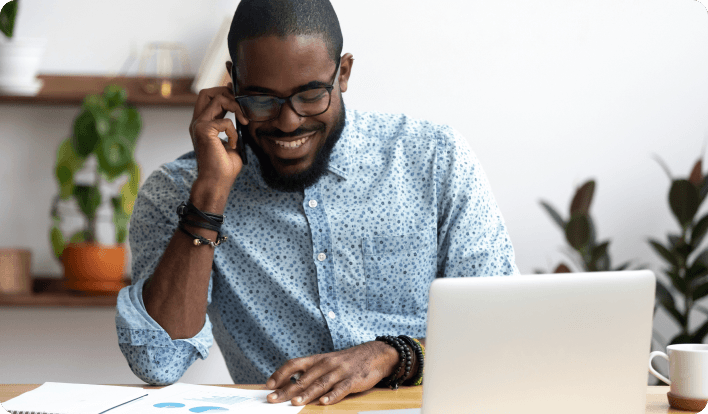 Man going over documents and talking over the phone