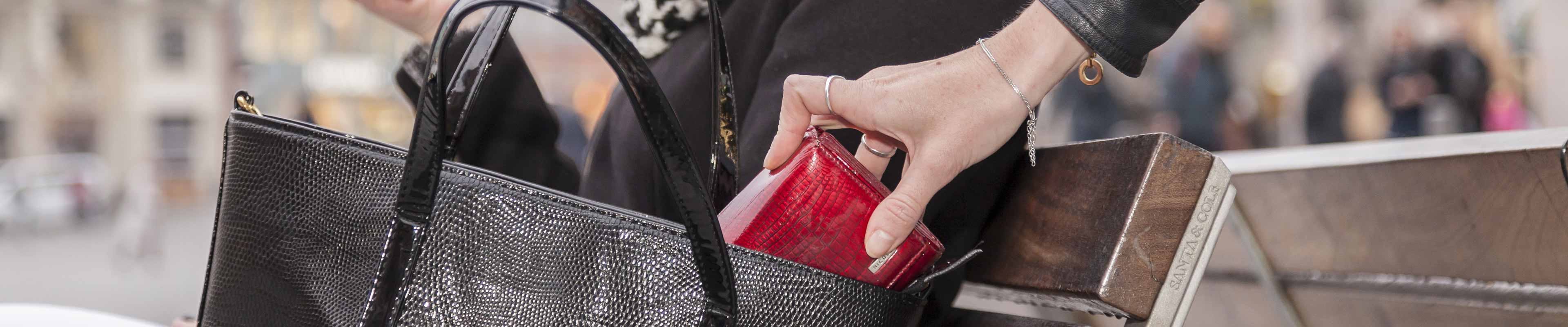 Purse on bench with woman stealing wallet for tax identity theft. 