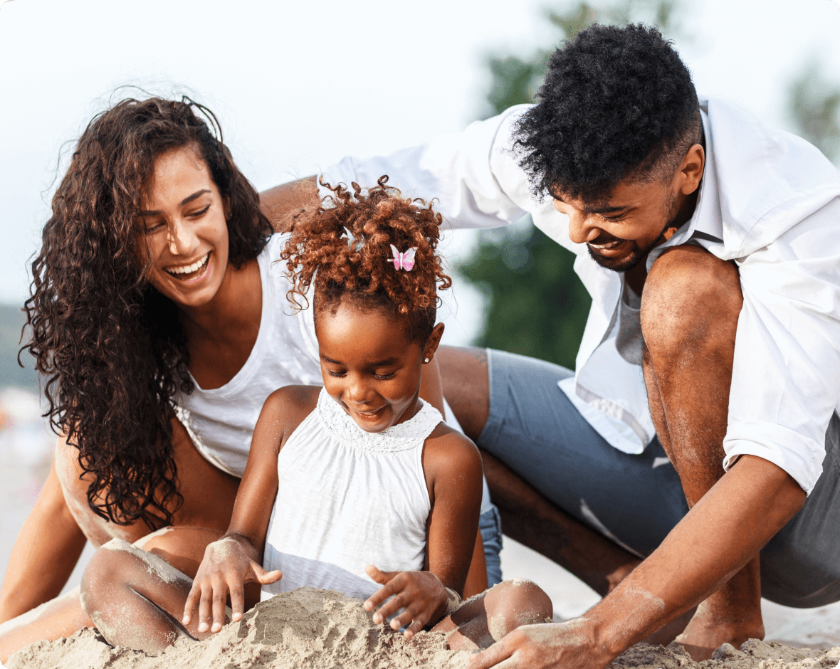 a family playing with sand